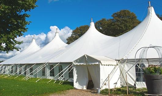 a row of portable restrooms placed outdoors for attendees of a event in Newbury